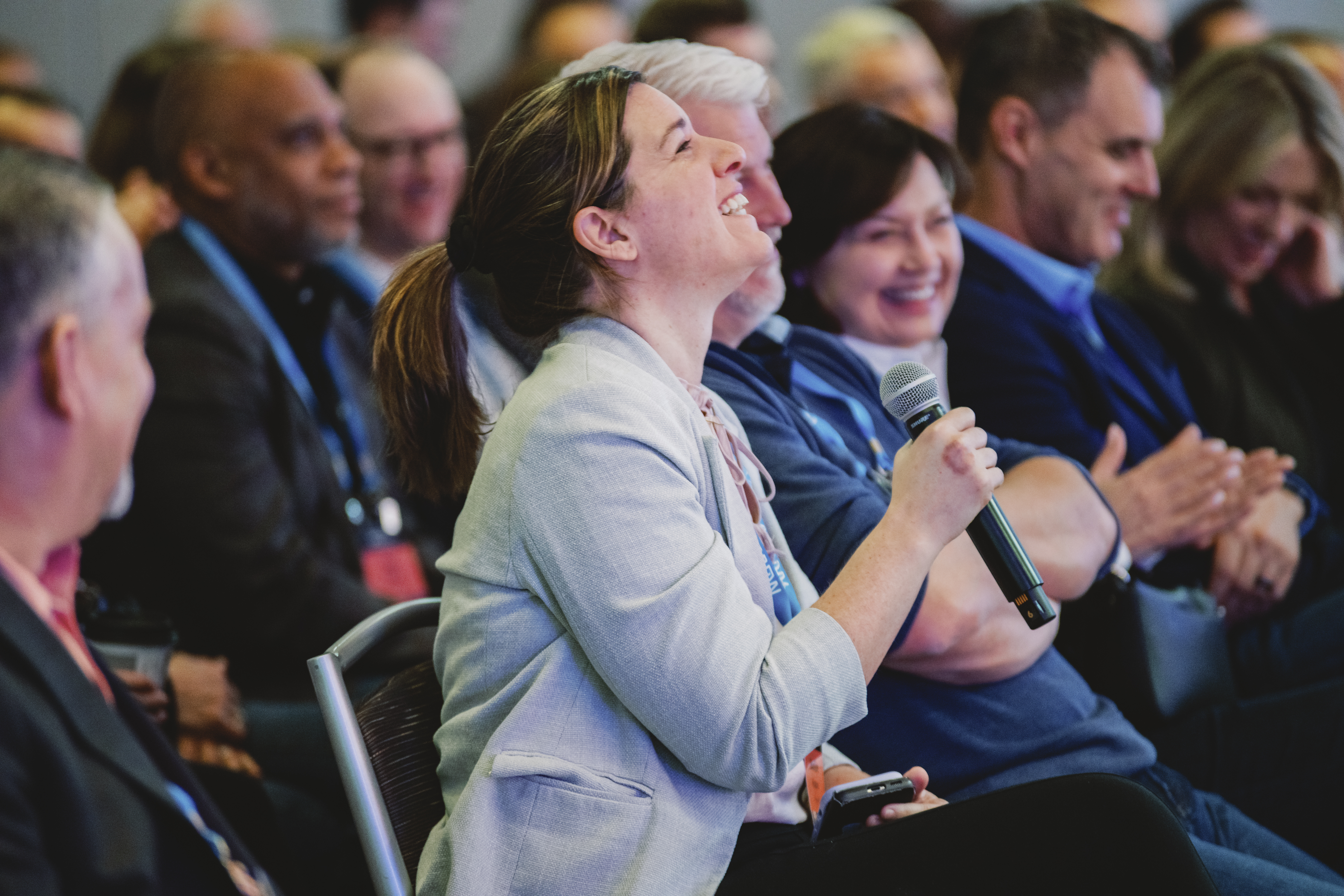 Candid conference photography showing attendee engagement at corporate event