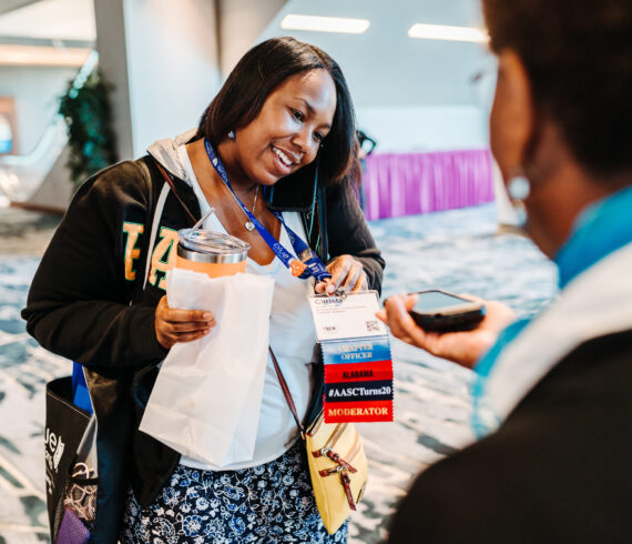 Conference attendee badge closeup showing event branding and sponsor visibility