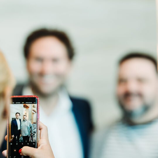 Multi-day conference coverage showing busy event floor by From the Hip Photo