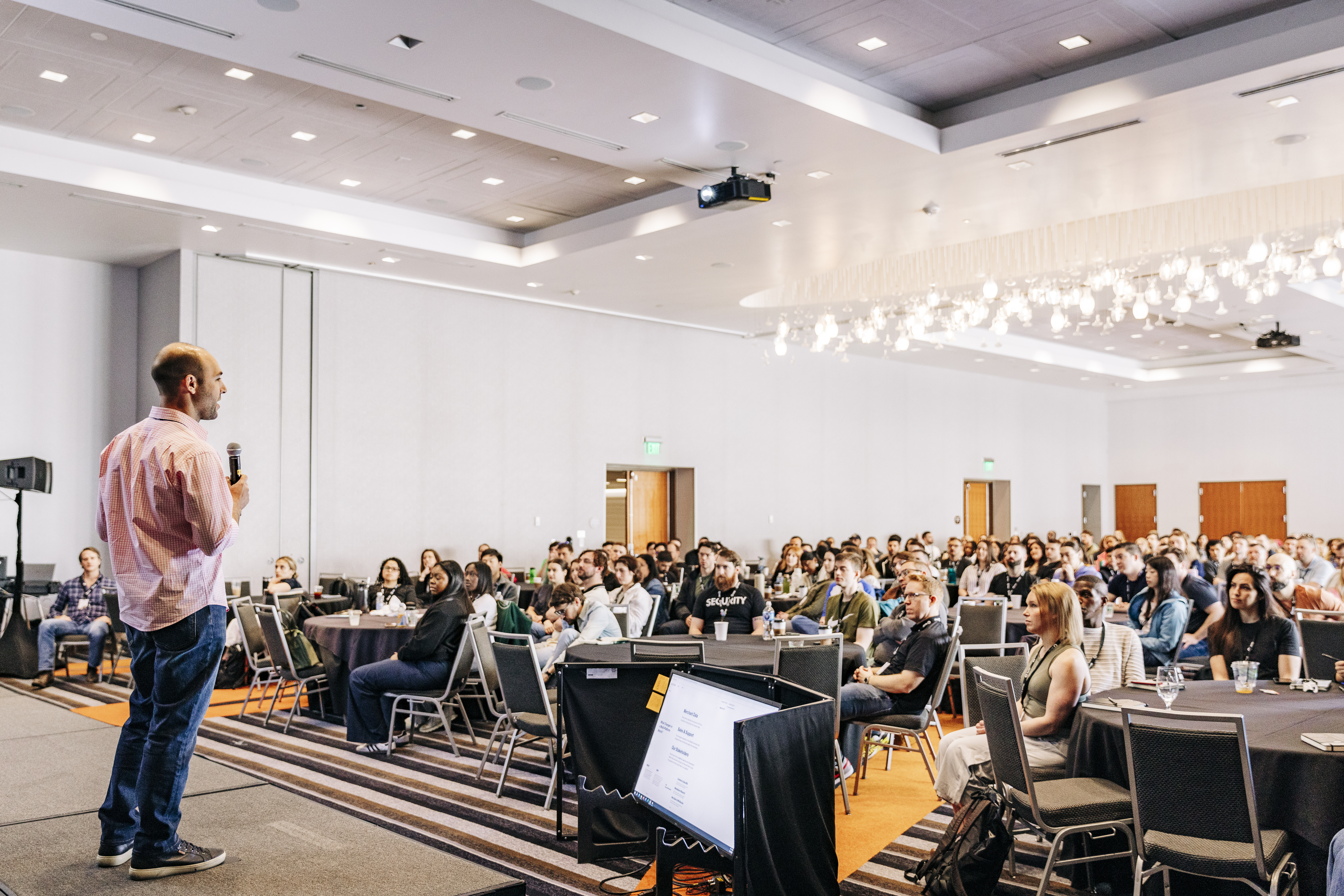 Event photography capturing speaker presentation at Denver conference