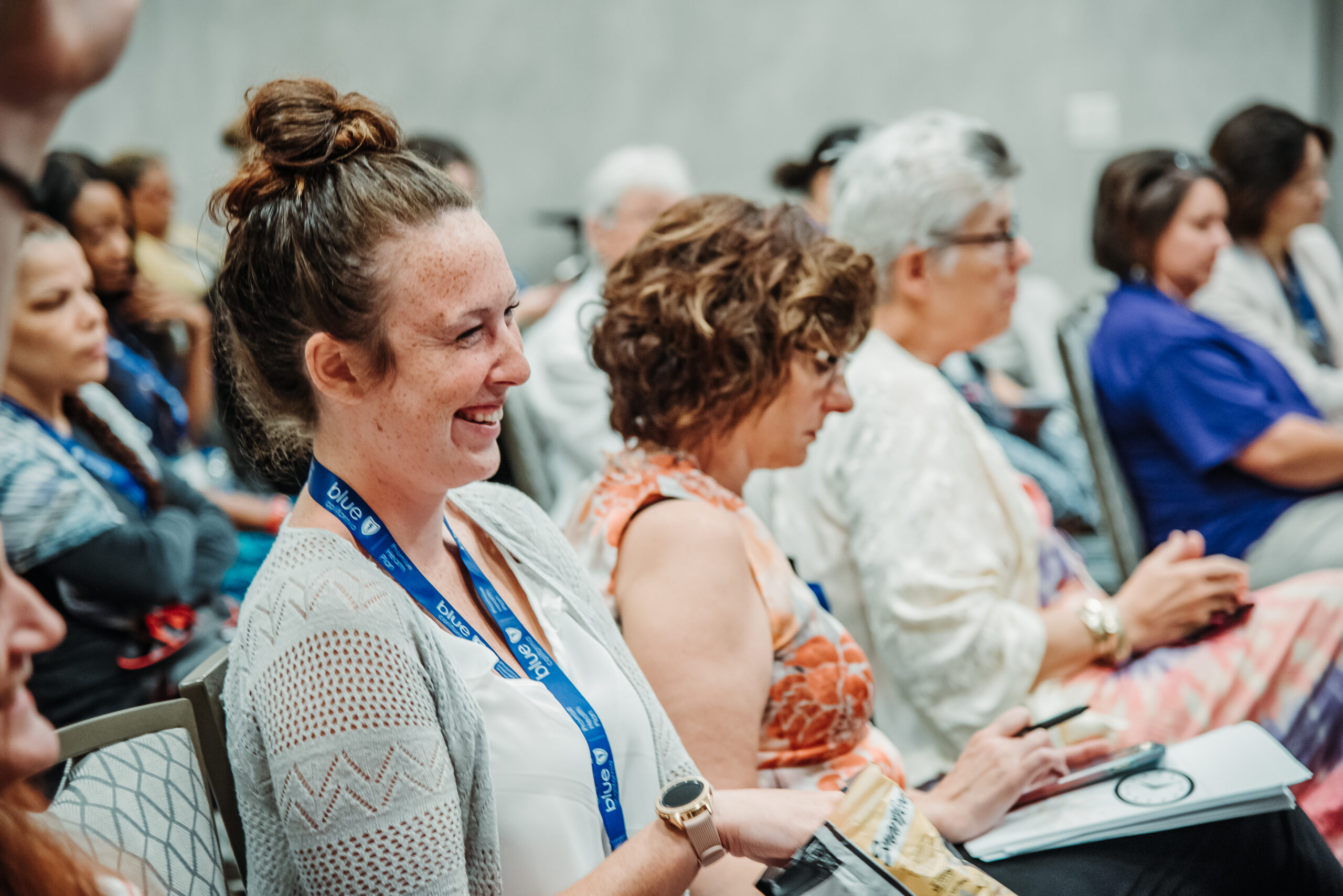 Conference attendees smiling during event session at Denver convention