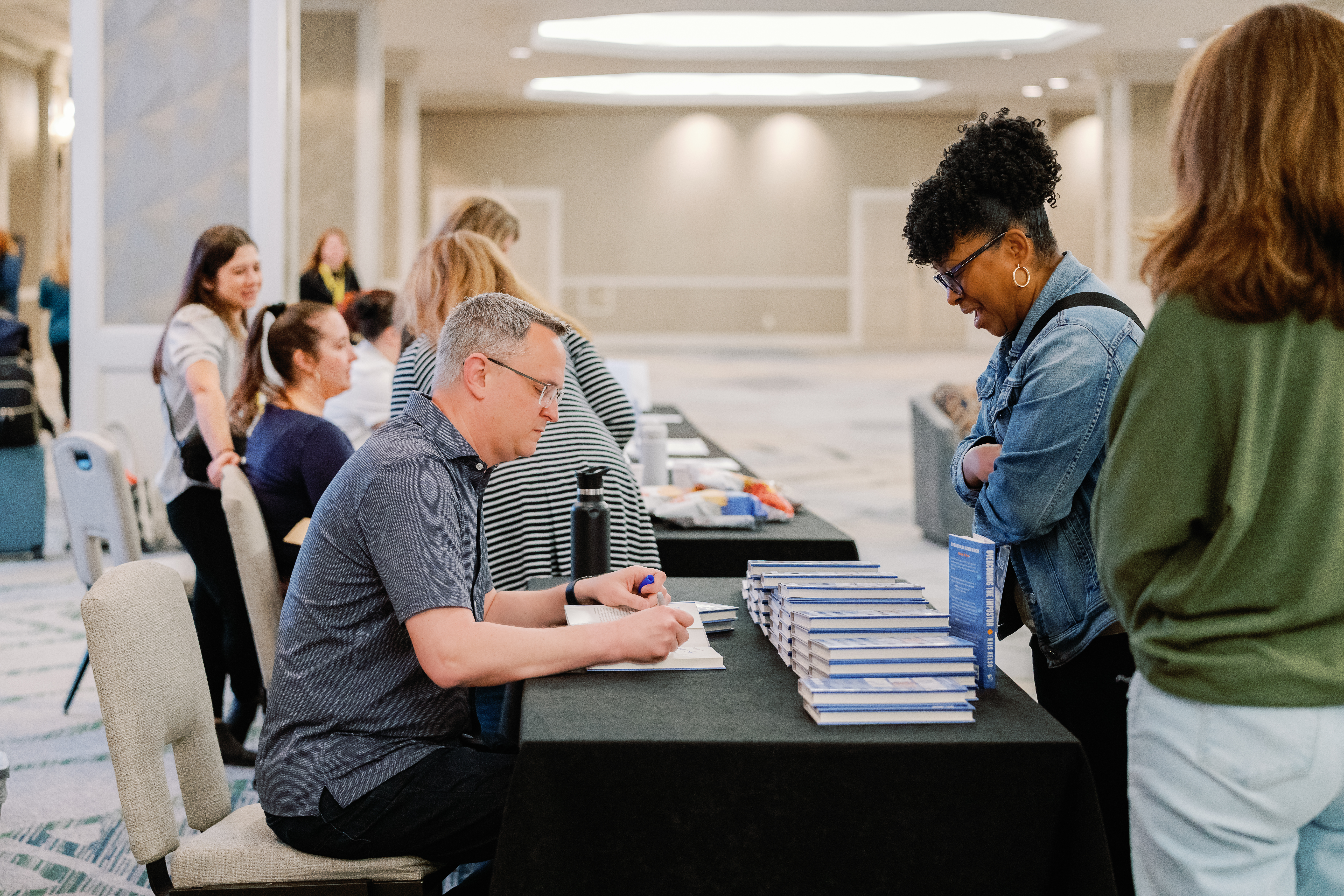 Conference attendees networking at Denver corporate event by From the Hip Photo