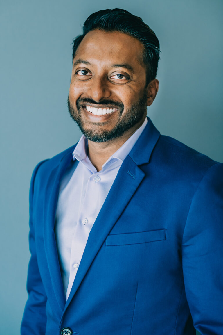 Professional conference headshot - man in blue blazer by From the Hip Photo