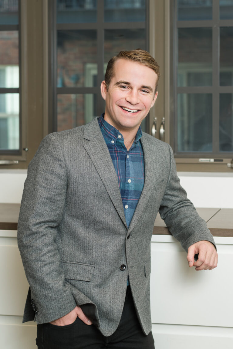 Professional conference headshot - man in gray blazer by From the Hip Photo