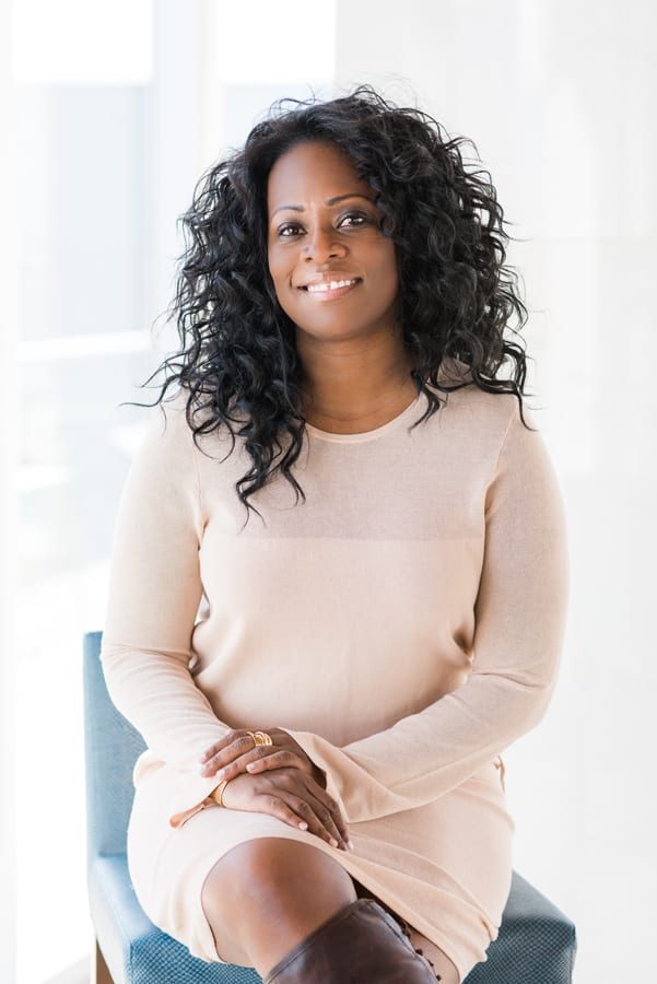 Professional conference headshot - woman in gray blazer by From the Hip Photo